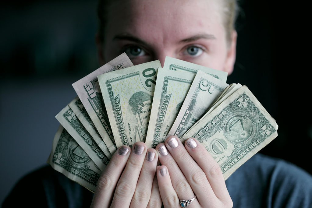 female holding cash