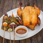 whole smoked chicken with vegetable skewers