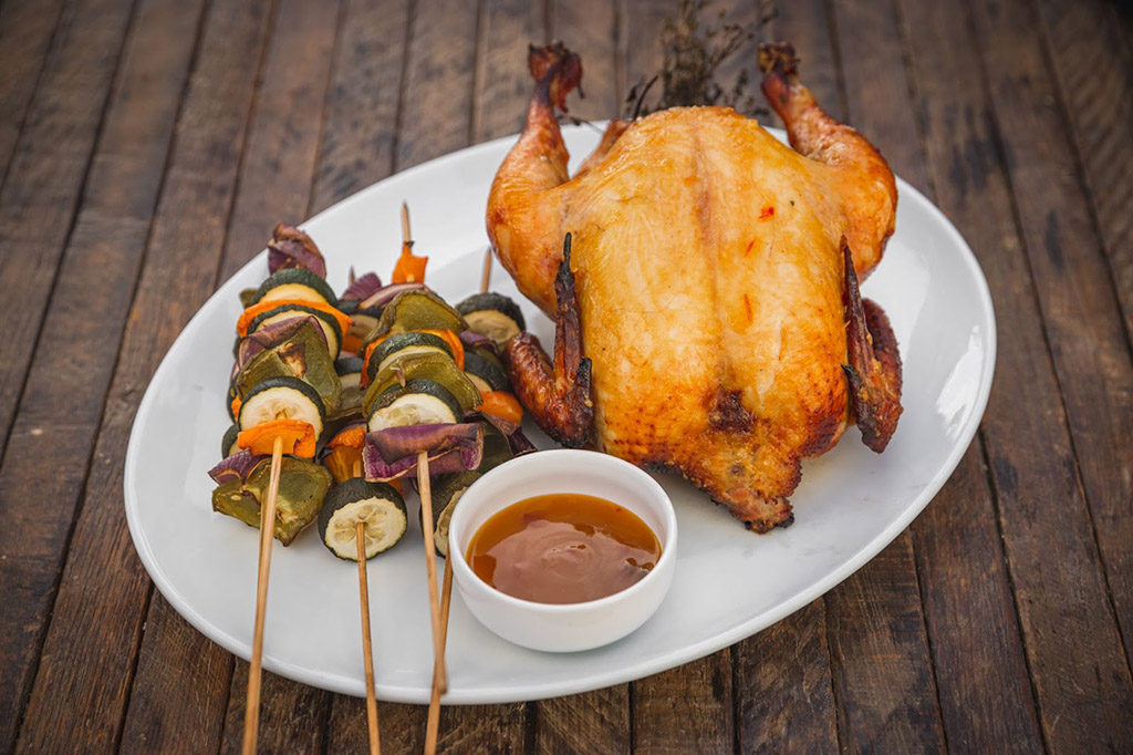 whole smoked chicken with vegetable skewers