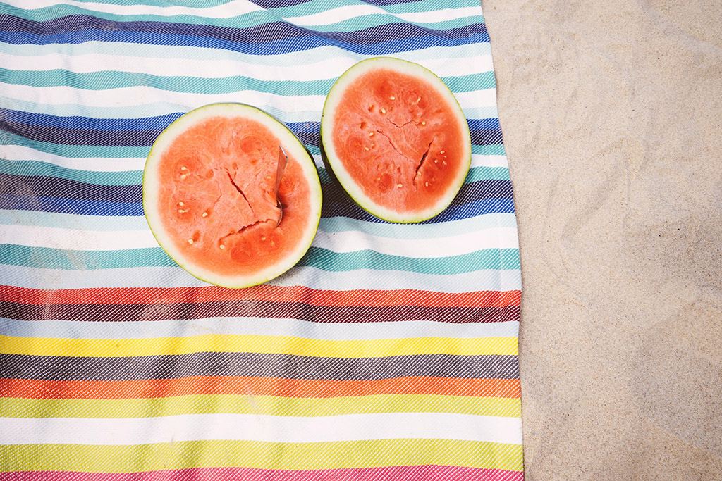 cut watermelon on a beach towel on the beach