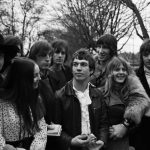 A black and white image of a group of friends in a London park.