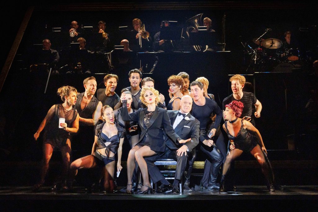 A full ensemble cast of Chicago in mid performance.
